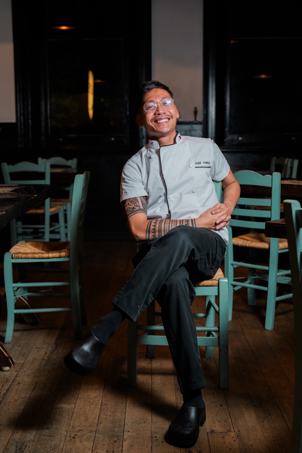 Chef Fhred Batalona seated in chef whites